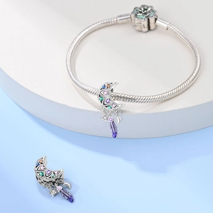 Detailed shot of moon dreamcatcher charm with colorful zircons on a silver snake chain