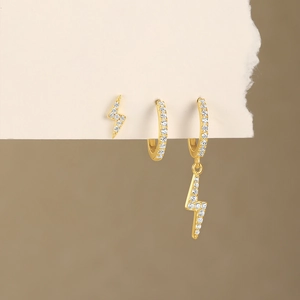 Macro view of gold plated lightning bolt earring set with sparkling cubic zirconia