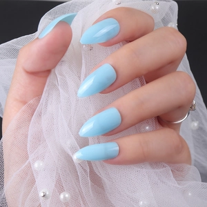 Glossy light blue almond-shaped press-on nails on hands with pearl tulle background
