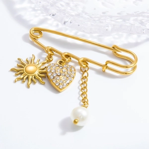 Elegant gold safety pin brooch with sun pendant, rhinestone heart and white pearl charm