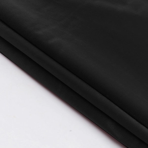 Close-up of high-quality black waterproof fabric texture with a subtle glossy finish
