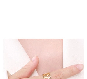Detailed close-up of a gold geometric cutout ring worn on finger for a stylish minimalist look