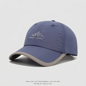 Detailed laser-cut mesh ventilation and mountain embroidery on kids outdoor baseball cap
