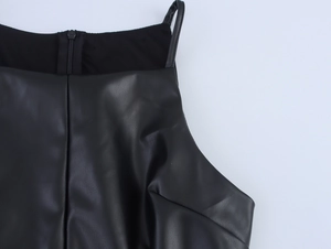 Detail view of the back zipper and thin shoulder straps on the black PU leather dress