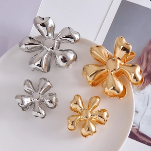 Glossy metal flower hair claws in gold and silver finishes, available in large and small sizes