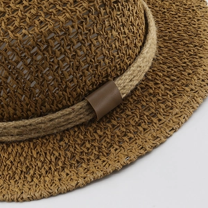 Close-up of hollow straw weave texture and hemp rope detail on flat top sun hat
