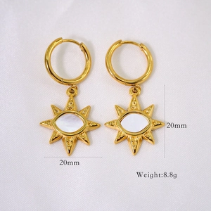Detailed view of sunburst gold earrings with white shell inlay and 20mm size scale