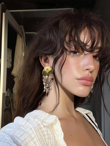 Macro detail of French vintage tassel earrings with pearls and crystal beads