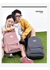 Outdoor shot of stylish pink and gray student backpacks with large front zipper pockets