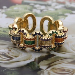 Macro detail of gold adjustable ring with multicolored zircon stones and micro-pave crystals