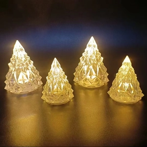 Detail of four crystal LED Christmas tree lights with warm yellow glow and faceted design