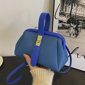 Textured blue leather handbag with gold metal clasp and versatile shoulder strap