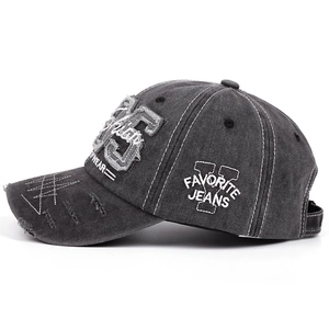 Distressed black 1985 vintage baseball cap with 95 patch embroidery and worn-out details