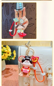 Detail of creative Chinese style cartoon doll keychain on a bag and car key