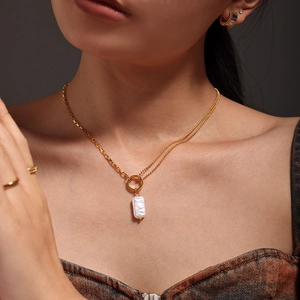 Elegant 18k gold plated stainless steel necklace with baroque pearl pendant worn by model