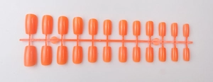 Detail of 24pcs vibrant orange short square press-on nails with shiny UV top coat finish