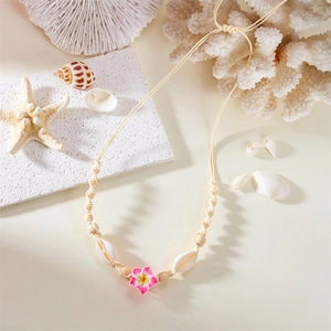 Detail of adjustable woven shell necklace with frangipani flower and natural wood beads