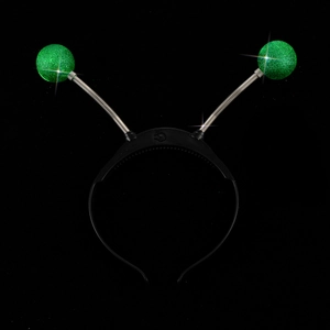 Detail of light-up alien headband with green glitter bouncy balls and silver springs