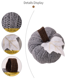 Detail display of gray knitted pumpkin with cloth leaf and lanyard for autumn decor