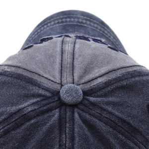Macro shot of 3D embroidery and reinforced stitching on washed cotton baseball cap