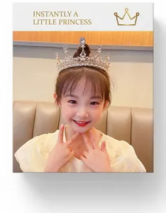 Close-up of a girl wearing a silver crystal tiara with pearls for birthday party events
