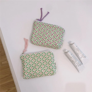Flat lay macro of small floral cotton pouches with zippers for jewelry storage