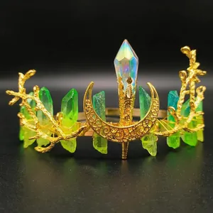 Detailed close-up of handmade gold branch crown with green crystals and moon accent