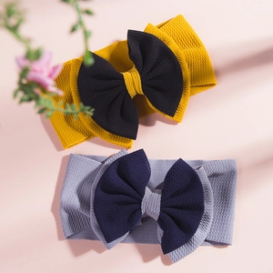 Detail view of ribbed fabric texture on baby bow headbands in contrasting color designs