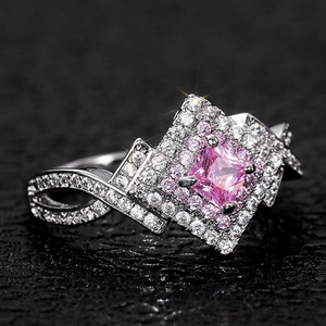Luxurious crisscross silver ring featuring a large princess-cut pink zircon center stone