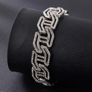 Detailed close-up of a silver-toned Cuban link bracelet with sparkling rhinestones