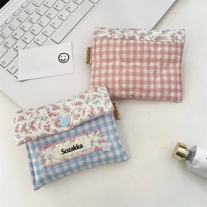Flat lay of Japanese style quilted floral fabric pouches on a tidy desk with a laptop