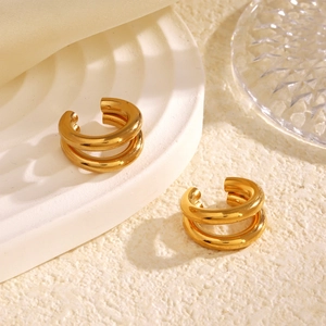 Minimalist double-layered gold ear cuff for women on a textured white display tray