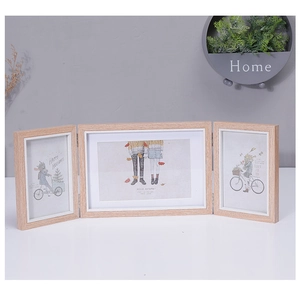 Detail of Nordic triple folding photo frame in light wood texture with metal hinges