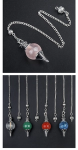 Macro detail of various colorful natural crystal pendants with metal pendulum chains