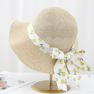 Breathable beige woven sun hat for women with green daisy ribbon and wide brim