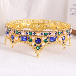 Detailed close-up of Baroque queen crown with blue gemstones and white pearls