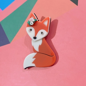 Cute orange acrylic fox brooch with flower detail on colorful geometric background