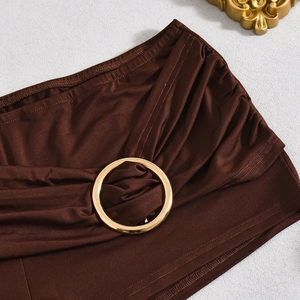 Detail view of brown shorts with pleated fabric and a gold metal ring buckle