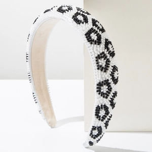 Close-up of handmade leopard print headband with black and white seed beads texture
