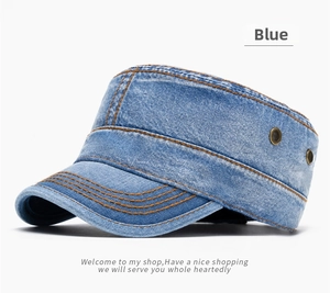 Detail of blue denim cadet cap featuring orange contrast stitching and metal eyelets