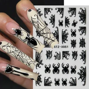 Detail of Halloween nail stickers featuring black spider web and gothic spider motifs