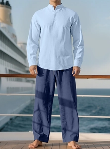 Men's light blue cotton linen shirt and navy drawstring pants on a cruise ship deck