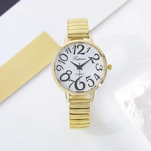 Close-up of golden quartz watch with large numerals and elastic band on white decor