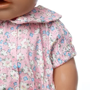 Detailed view of pink floral doll shirt with Peter Pan collar and elastic cuffs