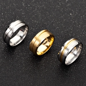Three matte titanium steel rings in gold, silver, and dual-tone with brushed finish