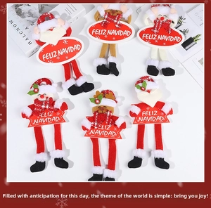 Close-up of plush Santa and reindeer Christmas hanging ornaments with Feliz Navidad signs