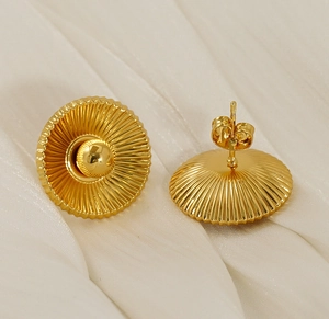 Detailed view of gold plated earrings featuring sunburst pleat texture and butterfly backs