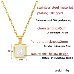 Detail of 18K gold plated stainless steel necklace with white shell and hollow letter M pendant