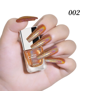 Macro detail of holographic laser nail polish in orange gold shade number 002