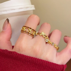 Gold plated open ring set with red enamel horse design and coin chain on model hand